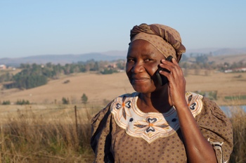 Traditional Zulu woman using a cellphone in Africa