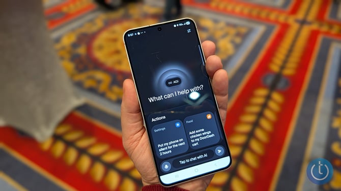 Screenshot of the AGI app on a phone held in a person's hand