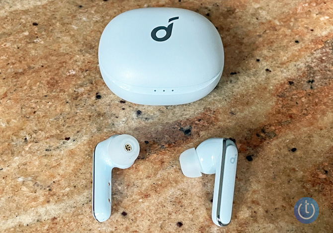 Soundcore by Anker Life P3 earbuds sitting below their case on a granite surface