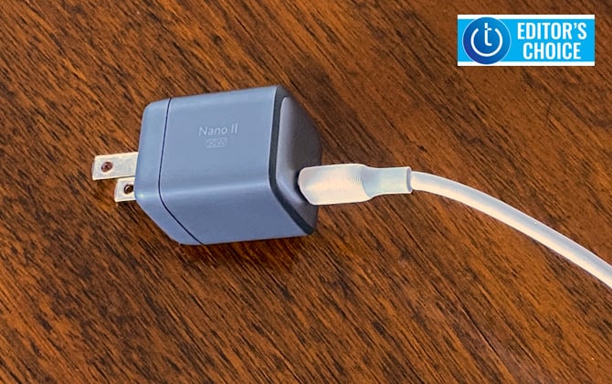 Anker Nano II 30 watt charger shown on table  with USB-C cord plugged in. Techlicious Editor's Choice award logo in upper right.