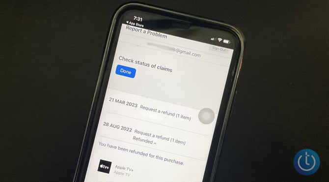IPhone on black background with screenshot of Apple Report a Problem website showing the status of a refund.