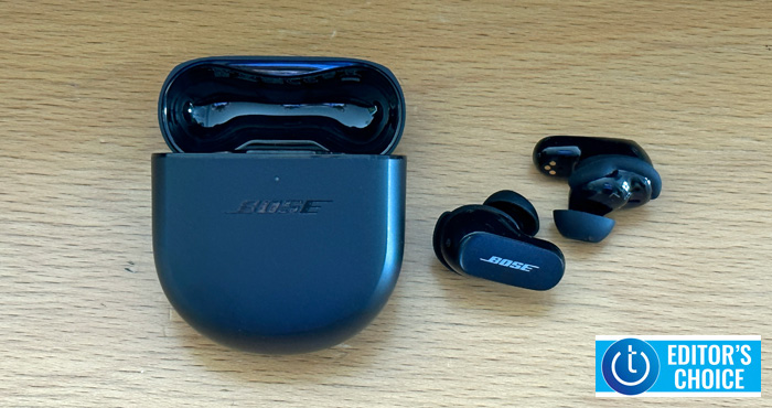 Bose QuietComfort Earbuds II on wooden table with case