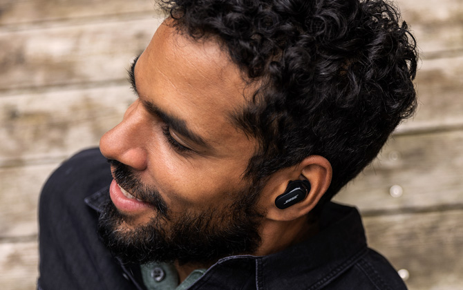 Man shown from the side wearing the Bose QuietComfort Earbuds II.