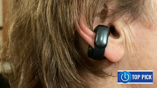 Bose Ultra Open Earbuds shown on ear. The Techlicious Top Pick award logo is in the lower right.