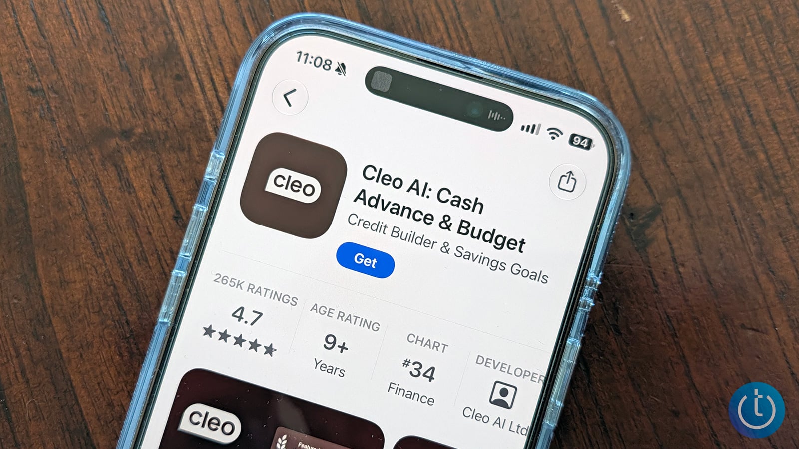 iPhone on a wooden table displaying the Apple App Store listing for Cleo AI: Cash Advance & Budget, with a 4.7-star rating.