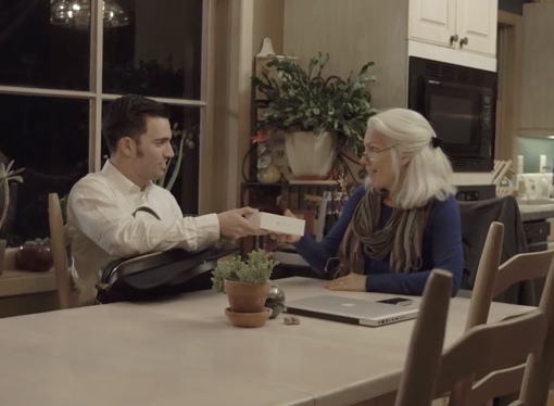 Man from ENJOY helping woman with cellphone
