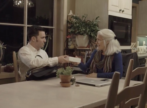 Man from ENJOY helping woman with cellphone