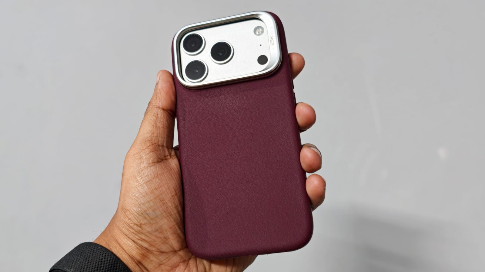 ESR Burgundy Atelier case on an iPhone 17 Pro, held in hand