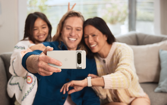 Three people on a sofa taking a selfie with the Google Pixel 8 Pro
