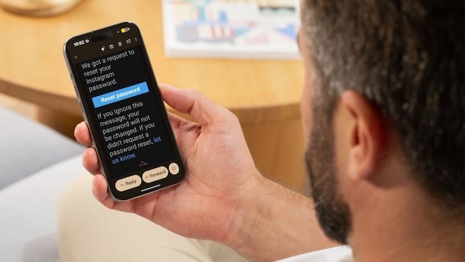 image of someone holding a smartphone. on the screen is a real email message with the button 