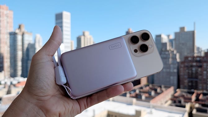 The INIU SnapGo Air is shown attached to the back of an iPhone 16 Pro Max.