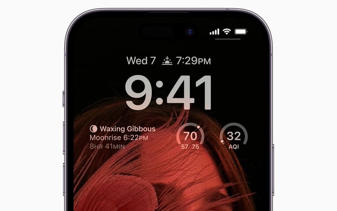 iPhone 14 Pro with always-on display. You can see weather information, time and the background photo.