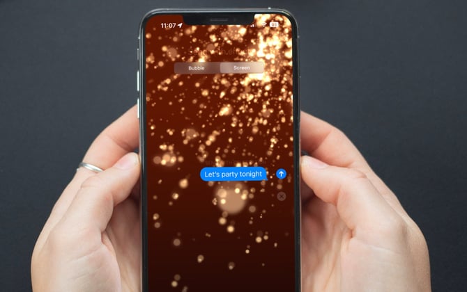 Hands holding iPhone with Messages app open showing Celebration full-screen text messaging effect.