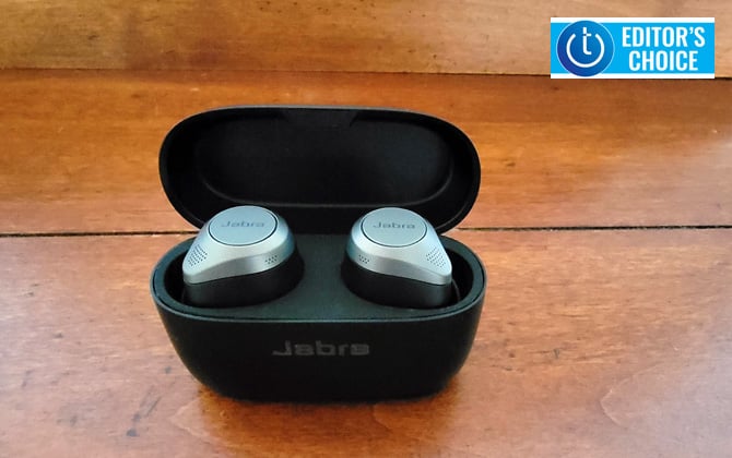 Jabra Elite 85t in carry/charging case on wooden surface. Techlicious Editor's Choice award logo in upper right.