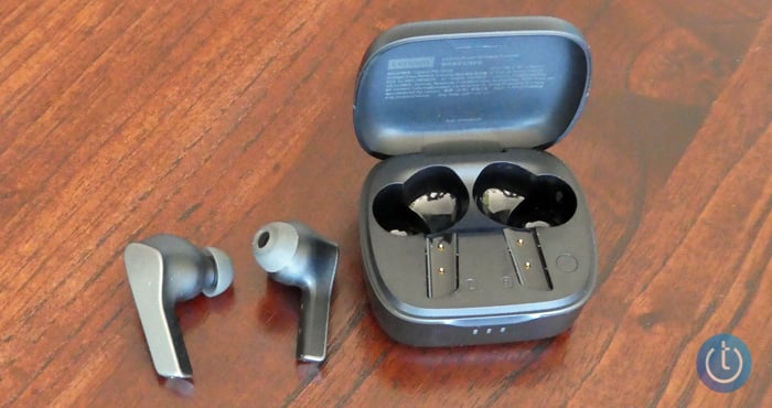 Lenovo Smart Wireless Earbuds out of case to the left of the open case