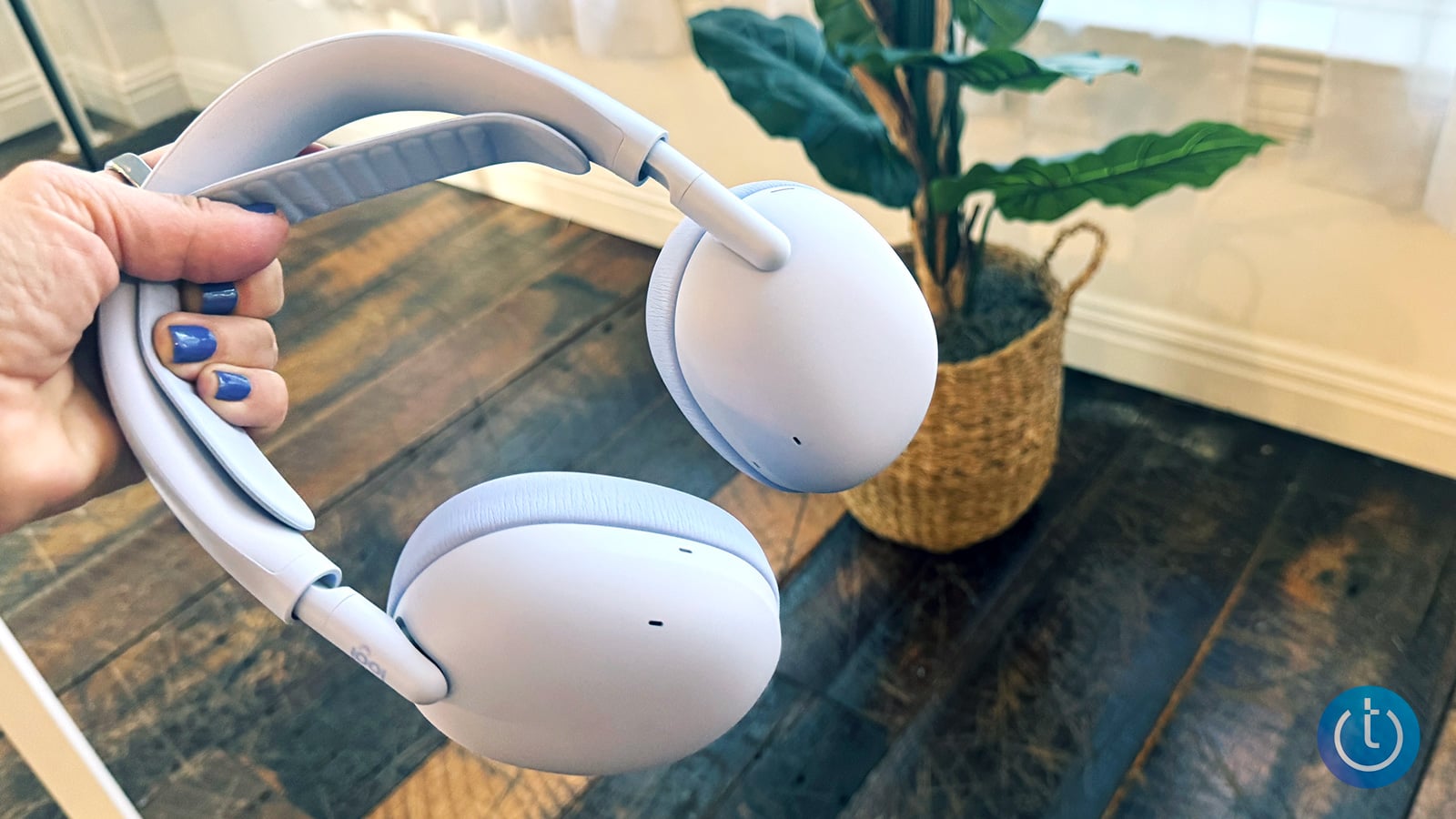 Logitech Zone Vibe Pro is held in the writer's hand.