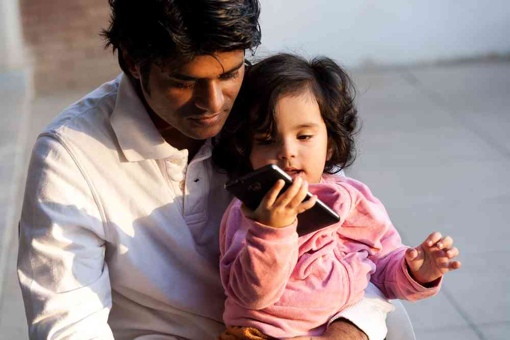 Man and daughter making a phone call