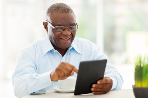 Man with glasses using tablet