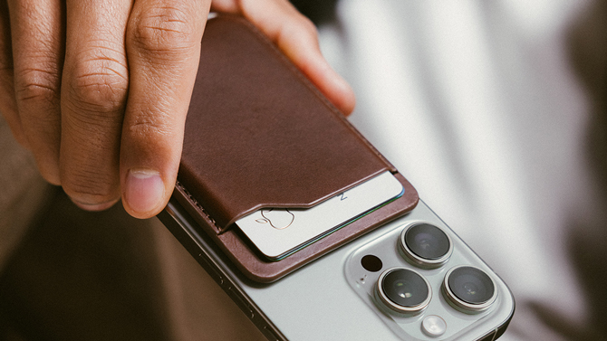 Nomad Mag Wallet in brown shown attached to an iPhone.