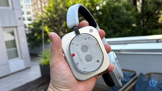 A closeup shot of the Nothing Headphone 1 right earcup. You can clearly see the button to switch media sources. 