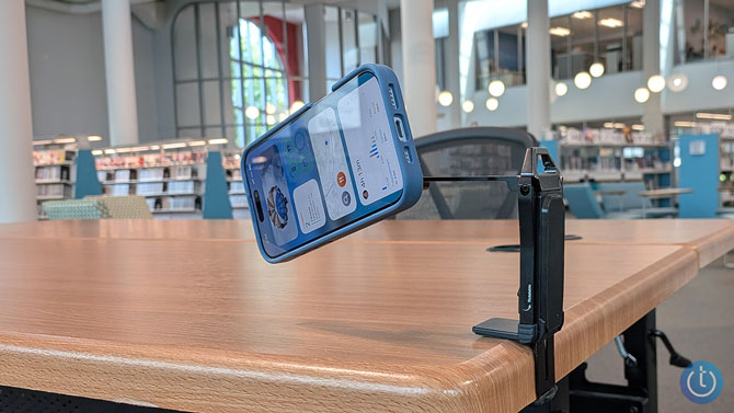 Omoton 360 Rotating MagSafe Tripod Mount is shown clipped to a table