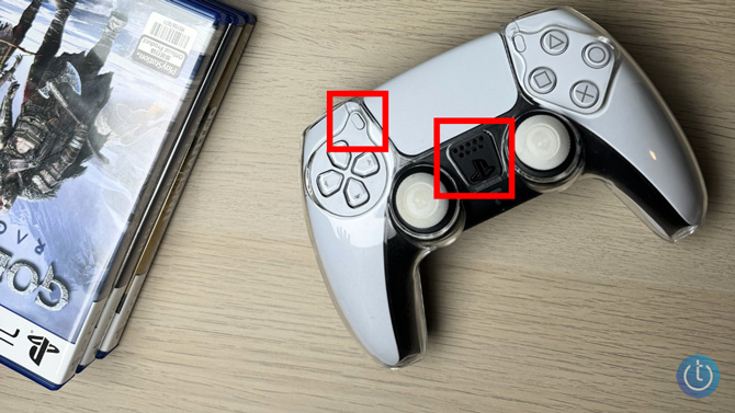 PS5 controller with two red boxes highlighting the buttons to push.