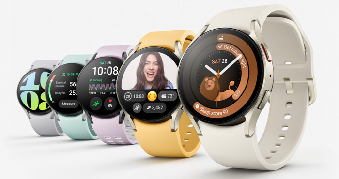 Samsung Galaxy Watch6 shown with different color watch bands, from the left gray, green, lavender, yellow, cream.