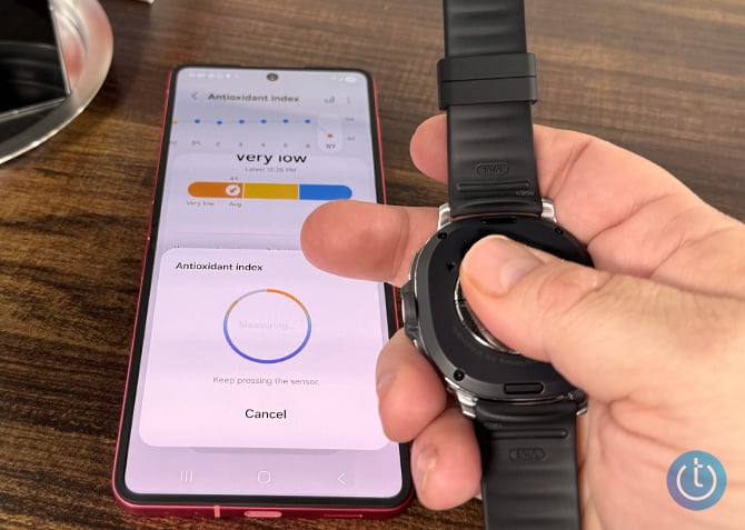 A thumb is pressed to the back of the Samsung Galaxy Watch8 to measure antioxidant levels.