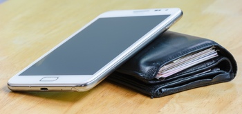 Smartphone resting on a wallet