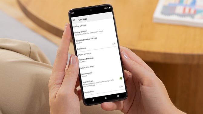 Settings screen for the SMS Backup and Restore app is shown on an Android phone