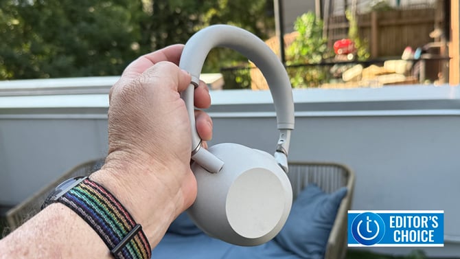 Sony WH1000-XM6 headphones held in the author's hand. The Techlicious Editor's Choice logo is in the lower right corner.