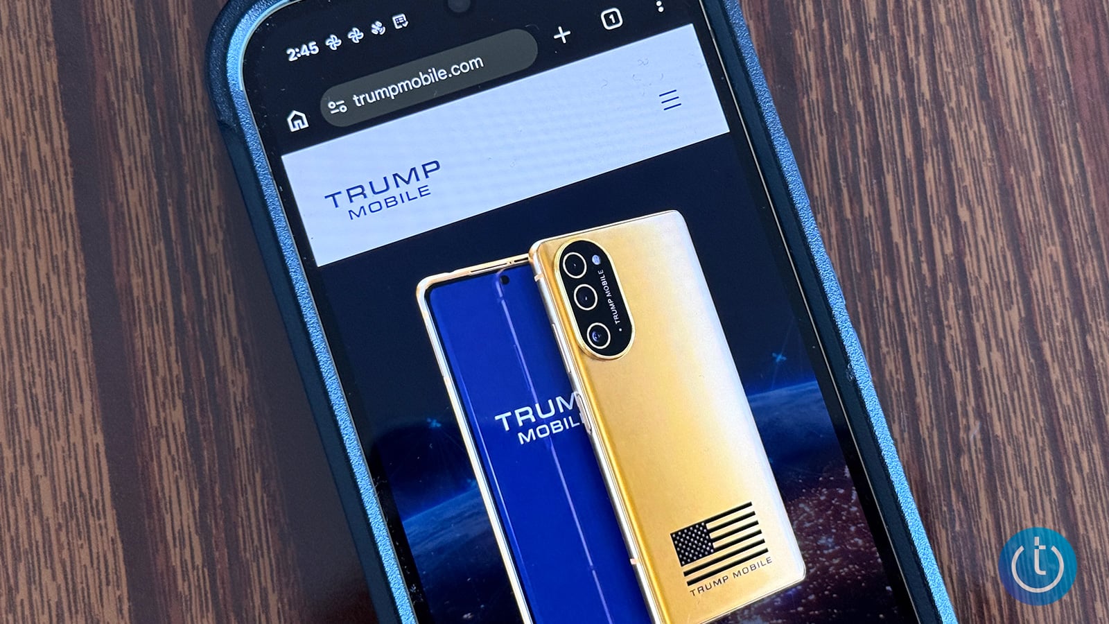  Smartphone on a wooden table displaying the Trump Mobile website with front and back views of a gold phone featuring an American flag.