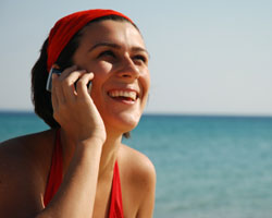 Woman on cell phone at beach