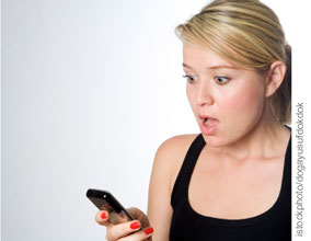 woman looking at cell phone with shock
