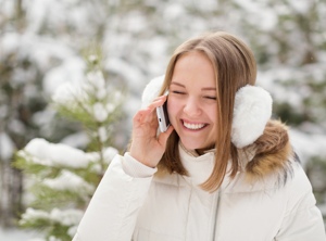 Woman using smartphone in winter